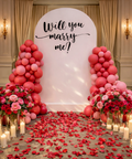 Decorated room with balloons, flowers, and 'Will you marry me?' sign in Abu Dhabi.