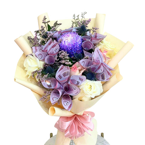 Bouquet made of flowers and rolled banknotes on a white background