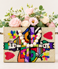 Inay blush pink and ivory fresh flower arrangement in a colourful Filipino handwoven bag by Danaya’s Flowers Abu Dhabi