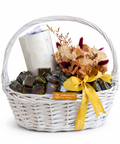 White ramadan gift basket with chocolates and flowers on a white background