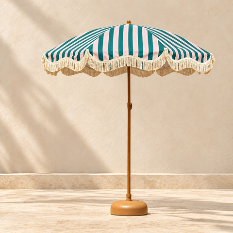 Teal, pink and white striped umbrella with cream fringe, wooden pole and weighted base.