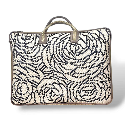 Woven bag with black floral pattern on a white background
