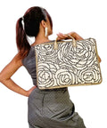 Woman holding a laptop woven bag with a white background