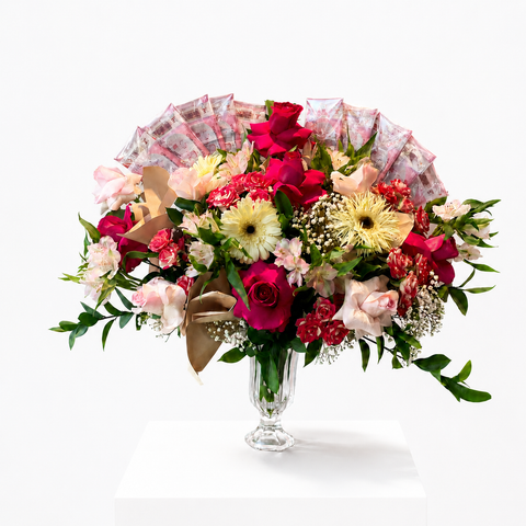 Luxury money bouquet featuring UAE dirham notes, red roses, white and pink flowers, and greenery in a glass vase.