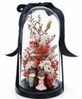 Preserved flowers in glass dome with couple figurine on white background