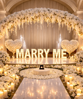 Decorated stage with 'MARRY ME' sign, flowers, and candles in a grand hall, Abu Dhabi.