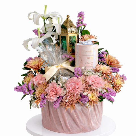 Luxury Ramadan flower arrangement with pink carnations, chrysanthemums, white lilies, chocolates and decorative lantern by Danaya’s Flowers in Abu Dhabi.