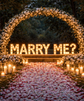 Decorative setup with 'MARRY ME?' sign surrounded by flowers and candles on a romantic night, Abu Dhabi.