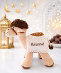 Personalized plush camel toy with Mohammad name embroidery in bright Ramadan setting with lantern and dates, UAE Eid gift