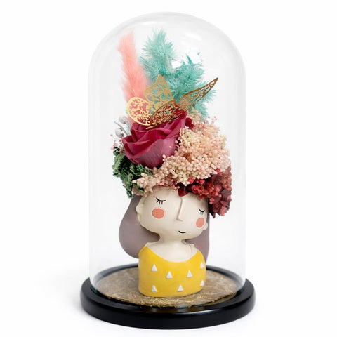 Handcrafted preserved flower arrangement in a glass dome with girl figurine, pastel florals, luxury gift decor on white background