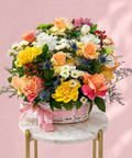 Colorful flower arrangement in a basket on a marble table with a pink background, abu dhabi delivery