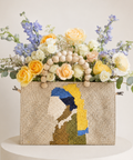 The Muse luxury woven bag flower arrangement with yellow and ivory roses, blue delphiniums and eucalyptus in Abu Dhabi