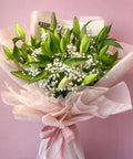 Premium white lily and baby’s breath bouquet symbolizing purity and peace, handcrafted luxury flowers in Abu Dhabi