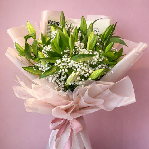 Premium white lily and baby’s breath bouquet symbolizing purity and peace, handcrafted luxury flowers in Abu Dhabi
