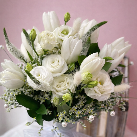 Elegant white tulip and rose flower bouquet with soft greenery and pearls, luxury floral arrangement in Abu Dhabi